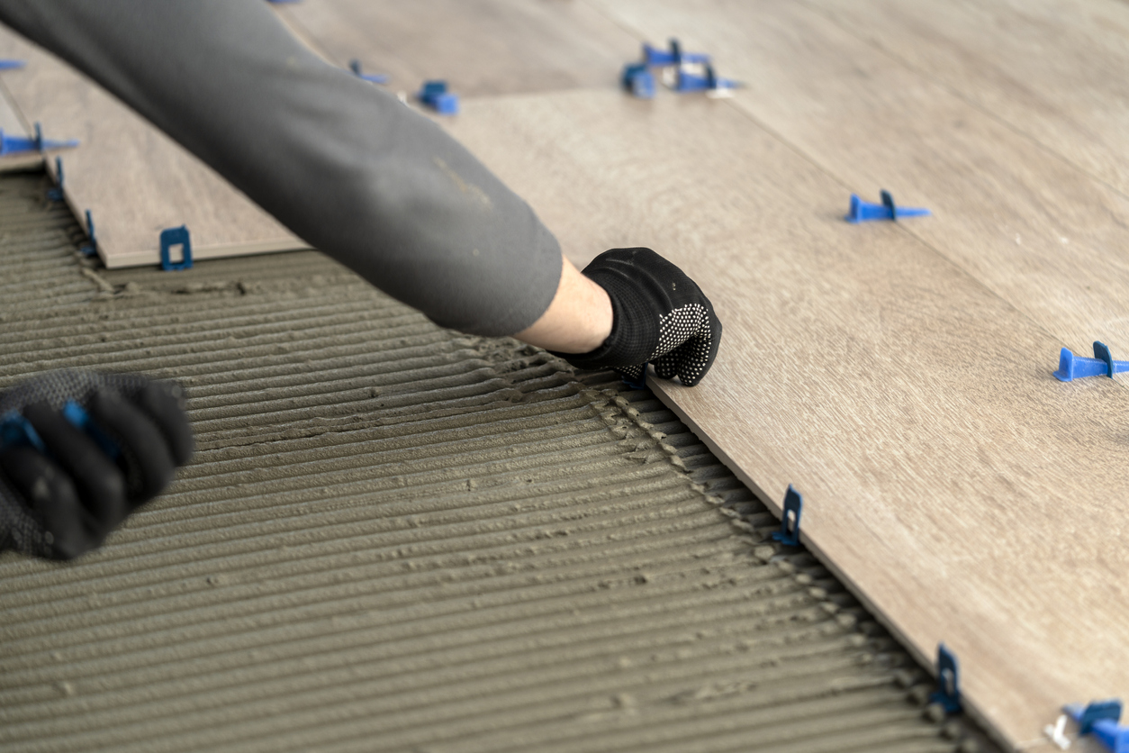 Man laying tile on floor